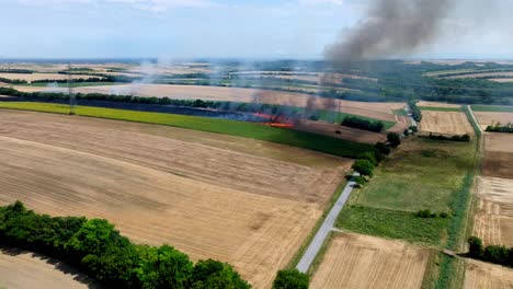 Bush-Fire-And-Smoke-In-Meadow-Field---Natural-Disaster---aerial-drone-shot
