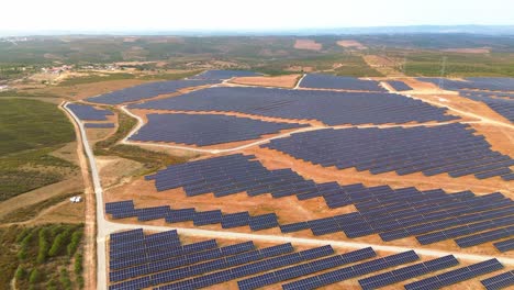 aerial-view-of-solar-farm-over-dry-land,-portugal,-4k