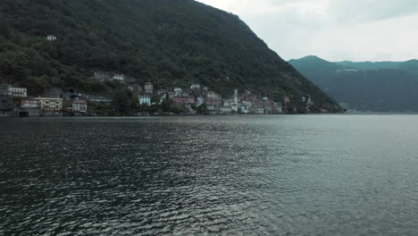 Flying-drone-point-of-view-of-Brienno-village-from-Como-Lake-in-Italy