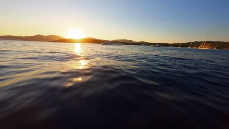 Scenic-FPV-aerial-flying-over-the-Mediterranean-Sea-in-Ibiza-toward-the-sunset
