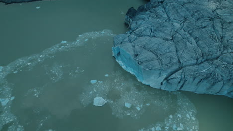 Icebergs-falling-in-the-water-while-a-Glacier-is-melting-due-to-climate-change