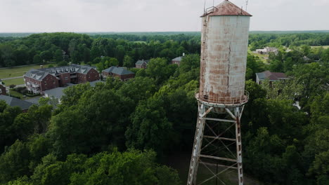 Aerial-circling-around-old-abandoned-water-tower-in-Lawrence-Indiana,-USA