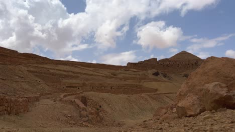 Panoramic-view-of-Ksar-Guermessa-troglodyte-village-in-Tunisia-with-moving-clouds-above