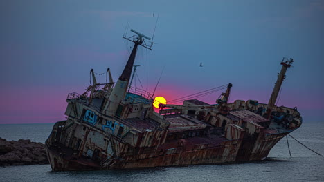 Stunning-sunrise-from-behind-the-wreck-of-a-freighter-laying-on-its-starboard-side