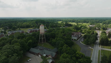 Fast-flyover-aerial-above-Fort-Harrison-state-park-with-water-tower,-Lawrence