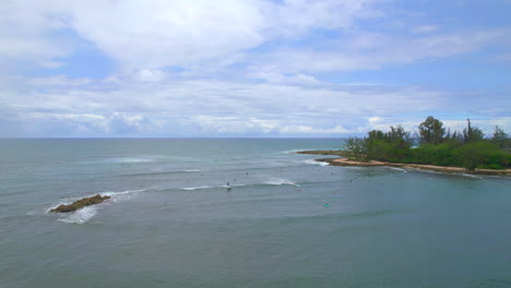 Surfers-off-the-coast-of-Pua'ena-Point-Beach-Park-Hale'iwa-Oahu-Hawaii-North-Shore-coastline