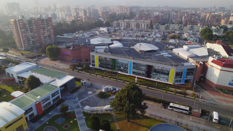 Aerial-Drone-View-Of-Local-Community-Shopping-Mall-in-Urban-Area-During-Morning-With-Glowing-Sunlight