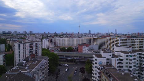 Beautiful-aerial-top-view-flight-City-Berlin-suburban-railroad-station-prefabricated-building-skyscrapers-district-Neukoeln,-Germany-Summer-day-2023