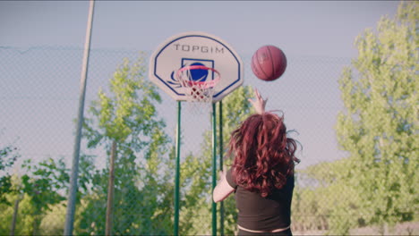 basketball-court-redhead-girl-dribbles-ball-towards-hoop-and-misses