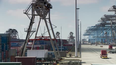 Cargo-cranes-and-container-tractors,-engineering-interaction-masterpiece,-port