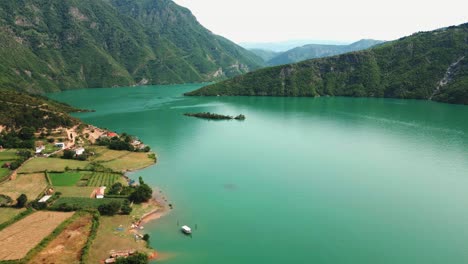 Albania,-emerald-waters-of-Lake-Koman-amidst-the-Accursed-Mountains,-aerial-view-from-a-drone