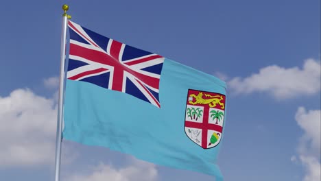 Bandera-De-Fiji-Moviéndose-En-El-Viento-Con-Un-Cielo-Azul-Claro-En-El-Fondo,-Nubes-Moviéndose-Lentamente,-Asta-De-Bandera,-Cámara-Lenta