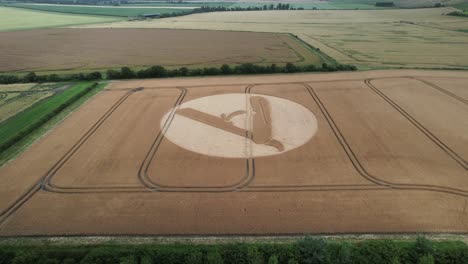 Establishing-aerial-view-over-cut-throat-razor-blade-crop-circle-on-Swindon,-Hackpen-hill-farmland-2023