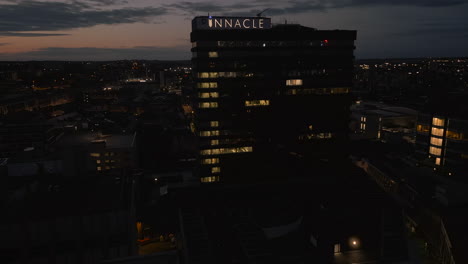 Establishing-Rotating-Drone-Shot-at-Night-Around-Pinnacle-Building-in-Leeds-City-Centre