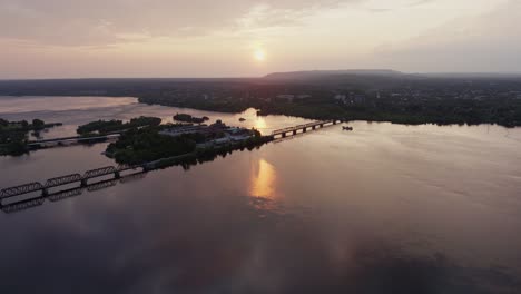 Sunset-Over-Nepean-Bay,-Establishing-Aerial,-Zibi,-Ottawa,-Canada,-Picturesque-Evening,-Smooth-Tracking-Left