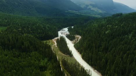 Cinematic-aerial-footage-of-the-Blaeberry-River-Valley-in-British-Columbia,-Canada-at-bright-daylight,-tilt-up,-Drone