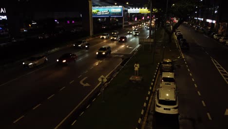 Traffic-camera-and-busy-night-street-of-metropolis,-aerial-view