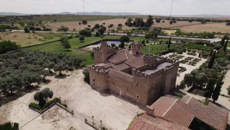 Aerial-view-circling-the-castle-of-Arguijuelas-de-Abajo-courtyard-grounds-in-the-city-of-Cáceres,-Spain