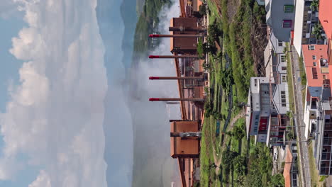 Steam-from-SLN-factory-in-Noumea,-New-Caledonia---vertical-time-lapse