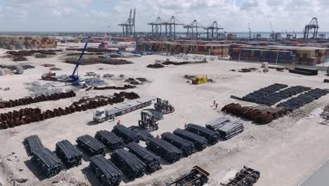 Piles-Of-Steel-Bars,-Forklift-And-Trucks-In-The-Multimodal-Caucedo-Port,-Boca-Chica,-Santo-Domingo,-Dominican-Republic
