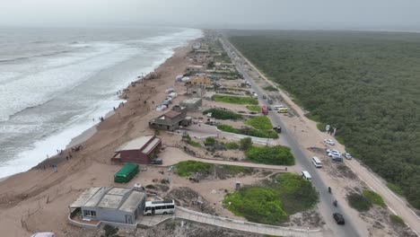 Aerial-View-Of-Beach-Huts-Beside-Hawkes-Bay-And-Mangrove-Forest-Plantation-In-Karachi