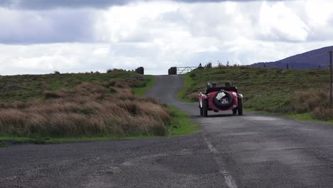 Classic-vintage-rally-car-starting-the-mountain-road-on-a-classic-car-rally-in-the-Comeragh-Mountains-Waterford-Ireland-early-summer