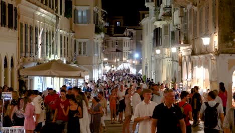 Tourists-Walking-in-Corfu-old-City-Street,-Crowded-Alley-in-Kerkyra-Greece-at-night,-Real-time-Shot