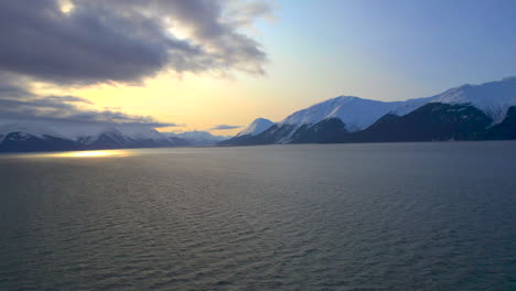 Flying-towards-the-sun-and-mountains-at-sunrise-on-the-scenic-biway-of-Seward-Highway-from-Anchorage-Alaska-to-Seward-Alaska