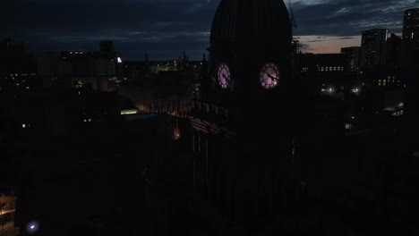 Drone-Shot-of-Leeds-Town-Hall-Clock-Tower-and-Leeds-City-Centre-Skyline-at-Dawn-in-Low-Light