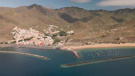 Las-Teresitas-beach,-in-the-Canary-Islands-of-Tenerife,-aerial-view-to-the-right-side,-with-a-view-of-its-fishing-village-San-Andres-01