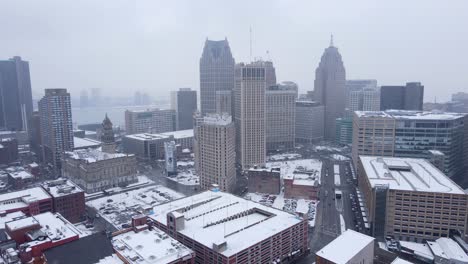 Skyline-of-Detroit-city-on-foggy-winter-day,-aerial-pan-left-view