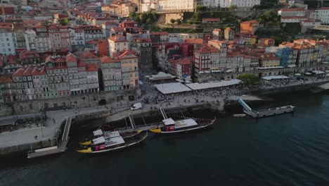 Aerial-view-of-Rabelo-boats-moored-at-Porto's-cais-da-Ribeira,-Portugal