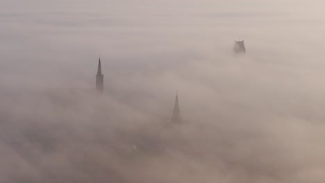 Aerial-view-of-elfsteden-stad-Bolsward-with-dense-fog-during-sunrise