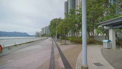 Dolly-along-river-canal-pathway-and-green-park-in-Hong-Kong