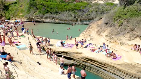 People-Swimming-and-Sunbathing-at-Canal-D'amour-Beach-Corfu-Greece,-Real-time-Footage
