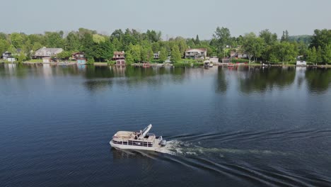Boat-Sailing-On-Scenic-Lake-At-Daytime---aerial-drone-shot