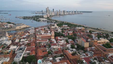 Aerial-of-colonial-old-town-of-Cartagena-with-the-modern-skyscrapers-in-the-background,-Bolivar,-Colombia