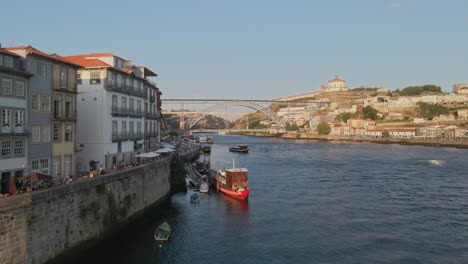 Aerial-Flyby-Oporto-Riberia-waterfront-towards-Dom-Luis-Bridge,-Douro-River