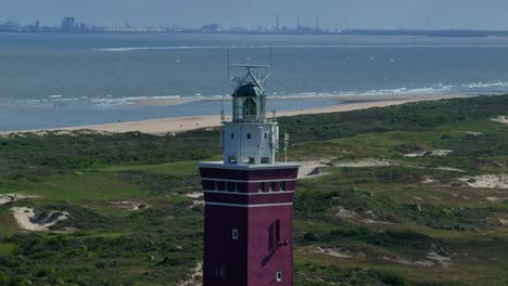 Close-up-of-Red-Brick-Structure-Of-Vuurtoren-Westhoofd-Lighthouse-In-Ouddorp,-aerial
