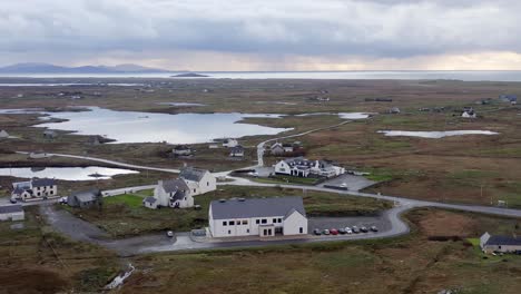 Anti-clockwise-point-of-view-drone-shot-of-Cnoc-Soilleir-in-the-village-of-Daliburgh-in-South-Uist,-part-of-the-Outer-Hebrides-of-Scotland