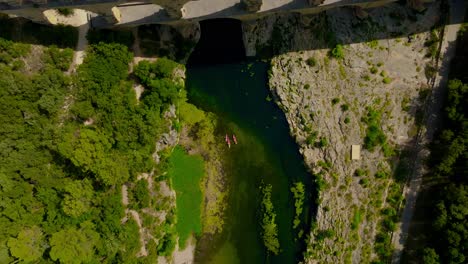 Top-down-aerial-view-above-the-"Pont-du-Gard"-bridge-and-the-Gardon-river-in-southern-France