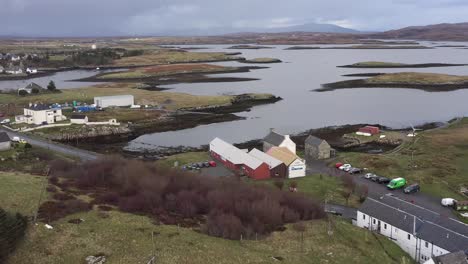 Advancing-drone-shot-of-the-Taigh-Chearsabhagh-Museum-and-Arts-Centre,-and-the-moor-and-peatland-surrounding-Lochmaddy-on-the-island-of-North-Uist,-part-of-the-Outer-Hebrides-of-Scotland