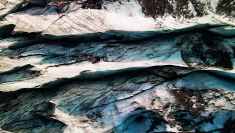 Drone-flies-over-blue-and-icy-glacier-in-Iceland