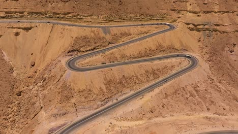 Aerial-view-of-Day-traffic-going-up-and-down-a-desert-mountain-winding-road