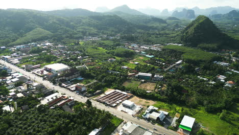 Aerial-view-on-highway-among-Ao-Nang-township-and-farmland,-Krabi,-Thailand