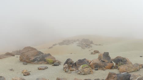 Foggy-Teide-desertic-landscape,-low-visibility-with-rocks-on-foreground