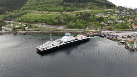Ferry-Rodvensfjord-from-Fjord1-comapny-crossing-fjord-on-Solsnes-to-Ofarnes-connection-in-Norway---Aerial-of-departing-ferry