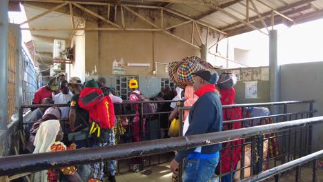 Shot-of-people-standing-in-line-to-buy-tickets-at-Banjul-Ferry-Terminal,-Gambia-Ports-Authority-at-daytime