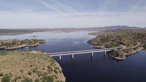 Bridge-spanning-river-across-desolate-Spanish-landscape