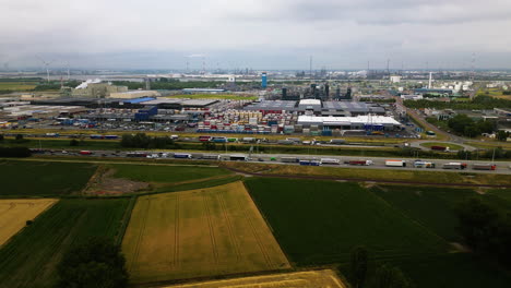 Industrial-export-and-import-facilities-near-highway-road,-aerial-view